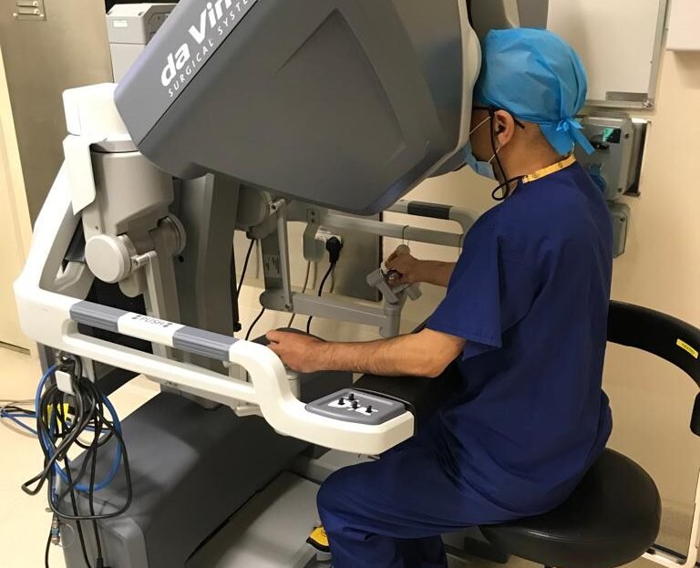 Mriganka De using robotic surgery equipment